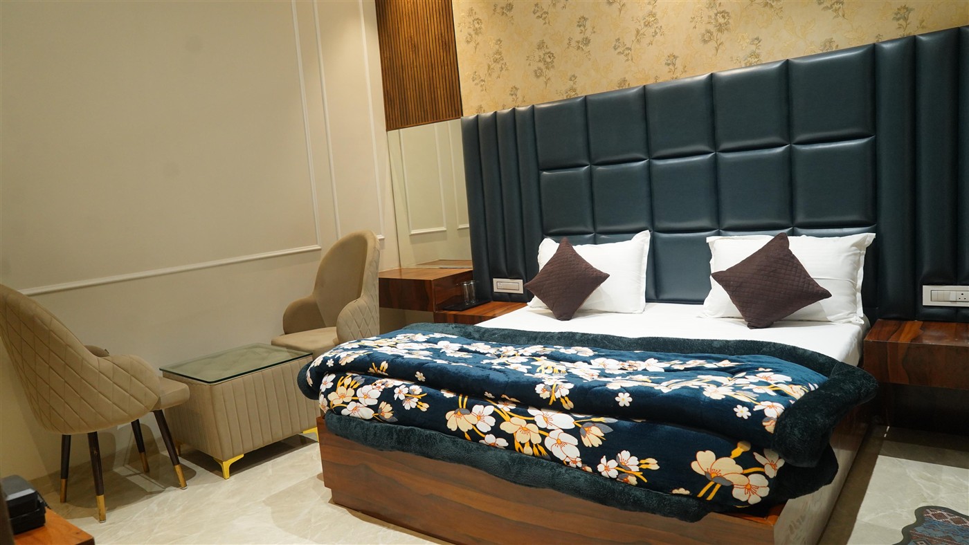 Designer room with blue headboard and floral bedspread at THE ROYAL KING couple friendly hotel Ludhiana